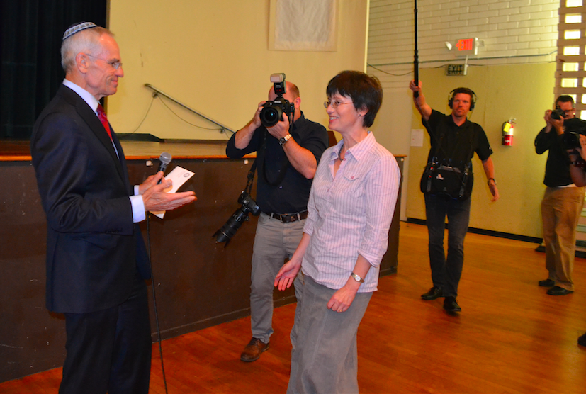 WINNER%3A++Cameras+clicking%2C+Richard+Sandlot%2C+vice+pesident+of+the+Milken+Family+Foundation%2C+presents+the+Milken+Jewish+Educator+Award+to+Ms.+Malikov+at+a+surprise+assembly+in+the+JCC+auditorium+Nov.+3.++%22We+are+all+in+this+together%2C%22+Ms.+Malikov+said.++She+did+not+know+she+had+won.