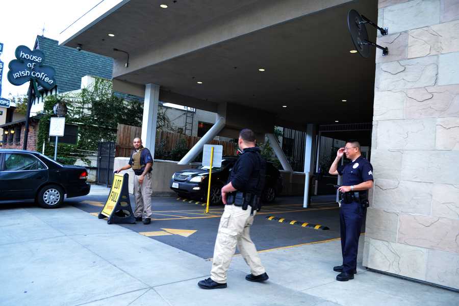 SUSPICIOUS: Extra security guards and police officers watched today's dismissal due to a suspicious phone call received this afternoon. They searched cars before allowing them through the gate.
