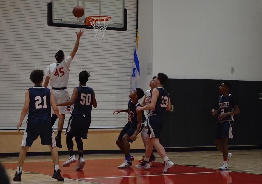 LAYUP%3A+Point+guard+Edan+Sokol+elevates+to+the+rim+in+the+second+round+against+Lancaster+High+School+in+the+CIF+playoffs+Feb.+17.