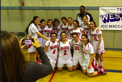 SMILES: It was a moment to savor for the Firehawk girls basketball team March 1 after defeating Glendale Adventist to win the Division title. Coach Ronnie "Flava" Winbush, at top, joined the post-game celebration.