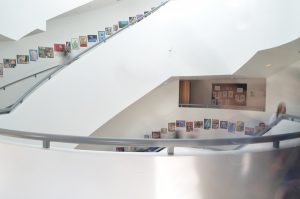 Similar to the Guggenheim's staircase, Shalhevet's staircase features white walls and circular stairways that overlook a foyer below. 