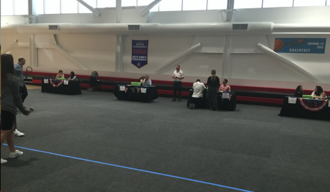 ORDERLY: Four voting stations were set up in the gym, one for each grade, overseen by teachers. People waited their turn in lines near the entrance.